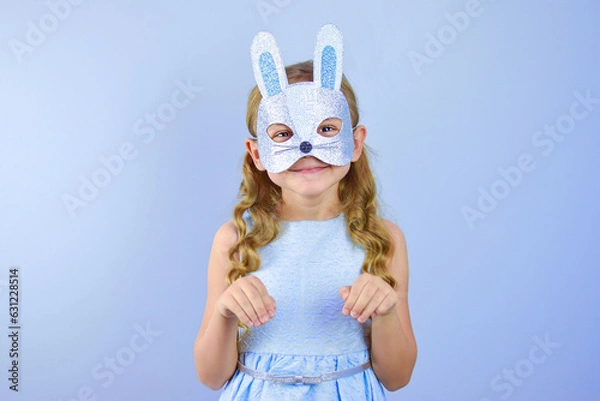 Fototapeta A child in a masquerade carnival mask of a hare or a rabbit, made by hand from shiny glitter foamiran and sequins. Masquerade, Carnival, Party, Holiday, Birthday