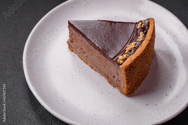 Fototapeta Delicious, fresh, sweet chocolate cake with nuts cut into slices