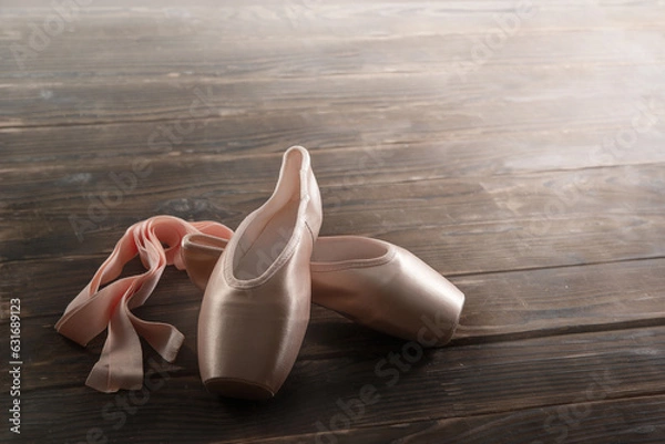Obraz Pointe shoes on a wooden floor, ballet shoes, ballet hall, close-up, copy space, background.
