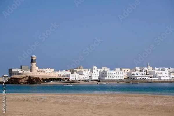 Fototapeta The lighthouse and the whitewashed houses of old town Sur in Sultanate of Oman