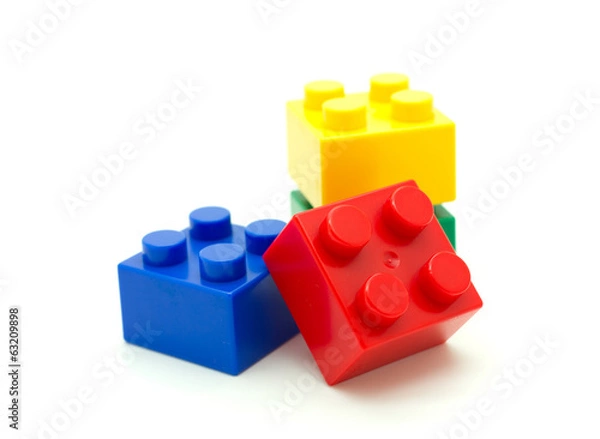 Fototapeta Plastic building blocks on white background