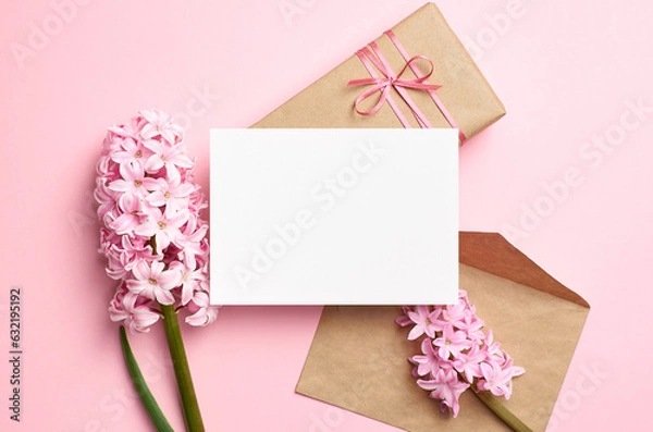 Fototapeta Blank greeting card mockup with envelope, gift box and flowers, white card mock up with copy space