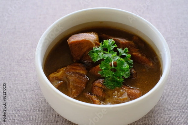 Obraz Stewed Pork Thai food. Pork leg stew on rice, or kao ka moo, is the quintessential Thai street food. 