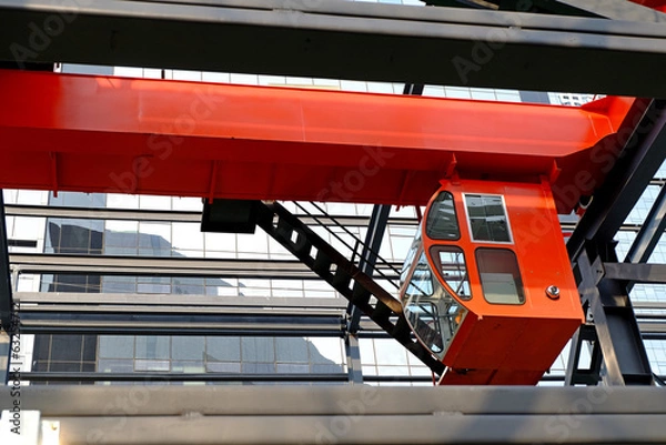 Obraz Overhead crane with an operator's cabin in the workshop of a machine-building plant.