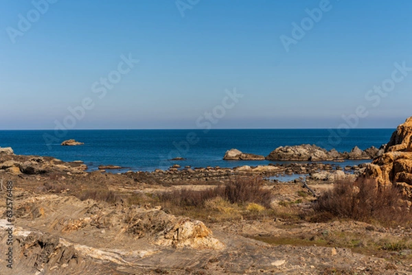 Fototapeta Cap de Creus Alt Emporda, Spain. February 2023 Rugged rocky coastline with turquoise waters in contrast. Sharp rocks extend out to the sea, creating a dramatic and wild texture.