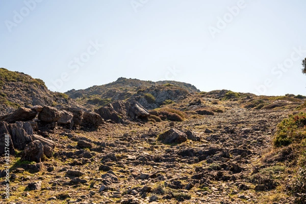 Fototapeta Cap de Creus Alt Emporda, Spain. February 2023 Rugged rocky coastline with turquoise waters in contrast. Sharp rocks extend out to the sea, creating a dramatic and wild texture.