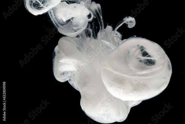 Fototapeta Abstract paint splash isolated on black background. Acrylic ink in water. selective focus.