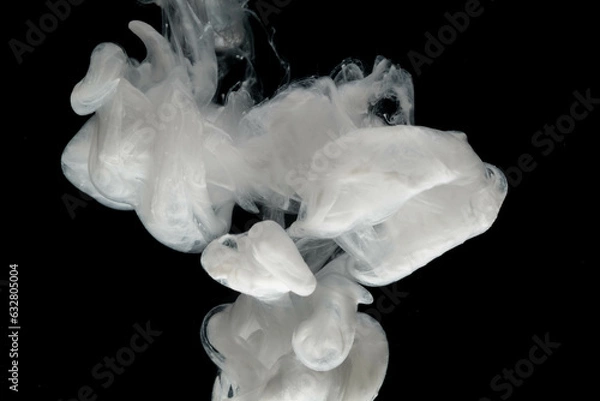 Fototapeta Abstract paint splash isolated on black background. Acrylic ink in water. selective focus.