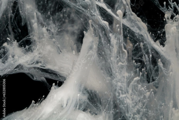 Fototapeta Abstract paint splash isolated on black background. Acrylic ink in water. selective focus.