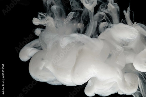 Fototapeta Abstract paint splash isolated on black background. Acrylic ink in water. selective focus.