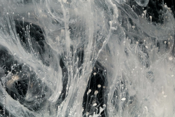 Fototapeta Abstract paint splash isolated on black background. Acrylic ink in water. selective focus.