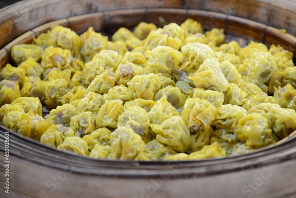 Fototapeta shumai dumpling in bamboo steamer on wooden background