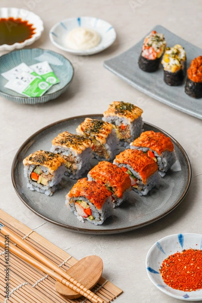Fototapeta sushi is a Japanese dish of prepared vinegared rice, usually with some sugar and salt, accompanied by a variety of ingredients such as seafood, often raw and vegetables.