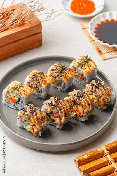 Fototapeta sushi is a Japanese dish of prepared vinegared rice, usually with some sugar and salt, accompanied by a variety of ingredients such as seafood, often raw and vegetables.