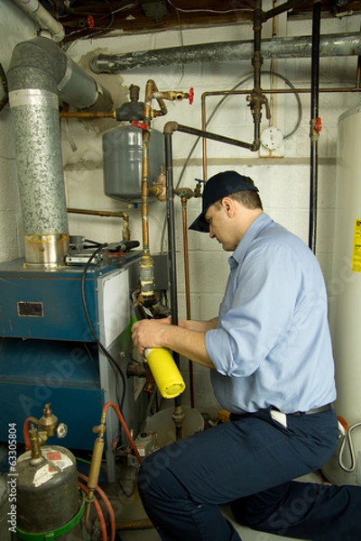 Obraz Service technician repairs furnace