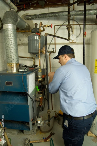 Obraz Plumber repairs furnace 