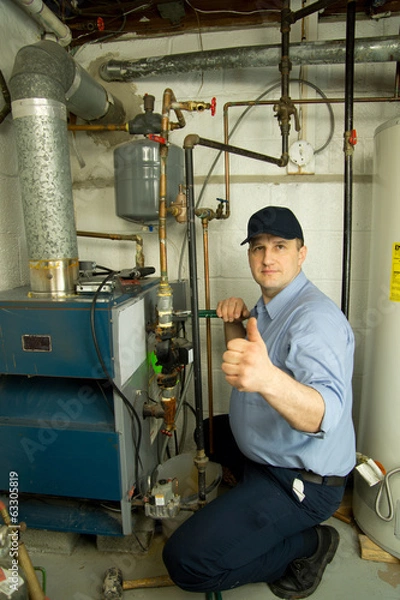 Obraz Plumber repairs furnace 