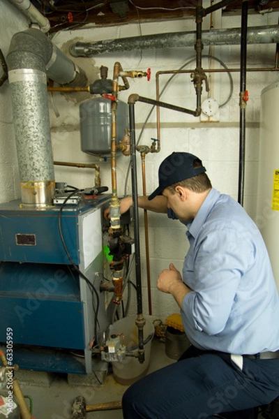 Obraz Plumber repairs furnace 