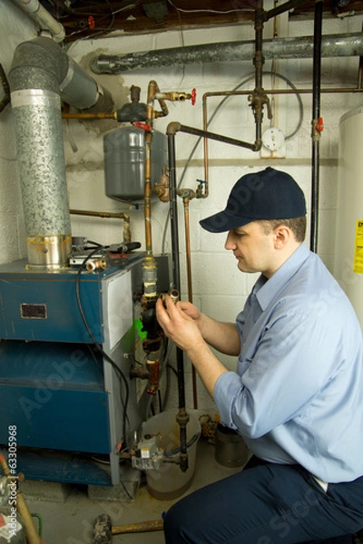 Obraz Service technician repairs furnace