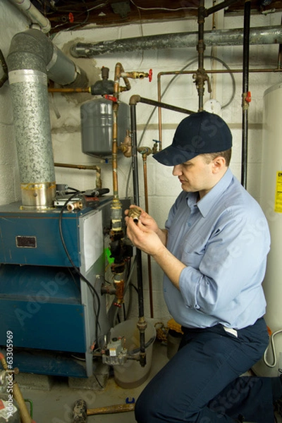 Obraz Plumber repairs furnace 