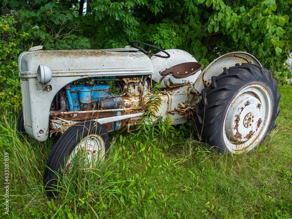 Obraz old rusty tractor in the field