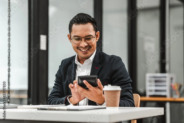 Fototapeta Handsome Asian businessman of Indian descent working at desk, digital asset exchange license, the world's largest cryptocurrency exchange by trading volume, registered recognized market operators