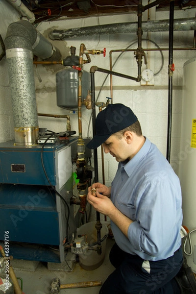 Obraz Plumber repairs gas furnace