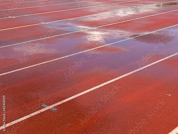 Obraz Wet running track reflection clouds.