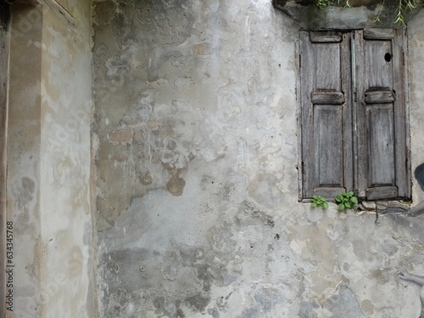 Fototapeta Old wooden window and rusty and grunge concrete wall surface.