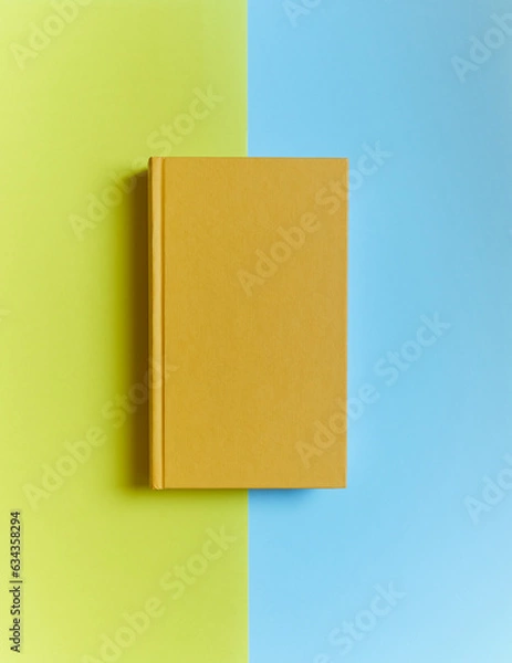 Obraz yellow book on yellow-blue background