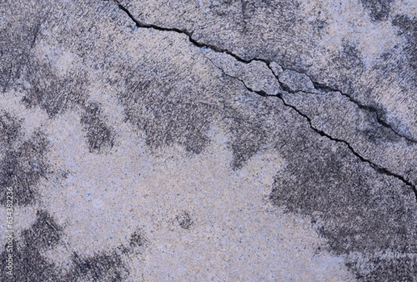 Fototapeta abstract background of creaked cement surface close up