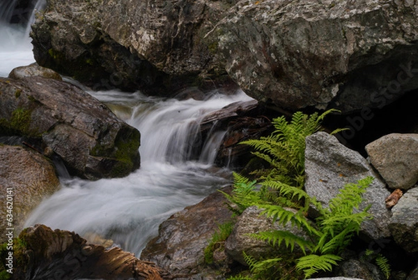 Fototapeta waterfall in the mountains with clear water low shutter