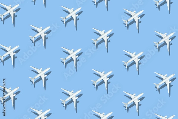 Fototapeta Contrasting pattern of toy planes on a blue background. View from above.
