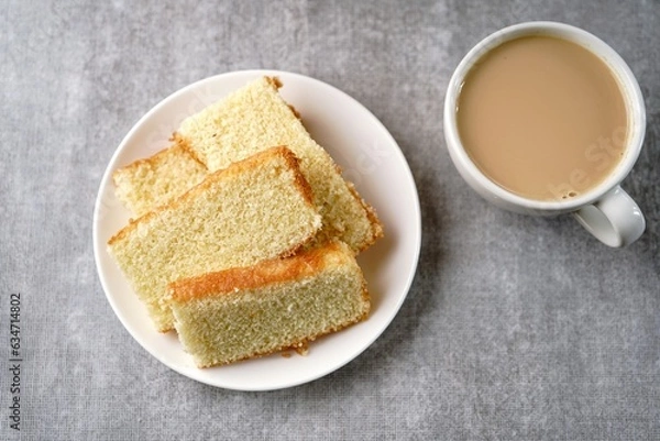 Fototapeta Homemade Indian butter tea cake served with cup of tea, selective focus
