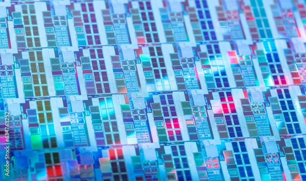 Fototapeta silicon wafer with microchips reflecting different colors.
