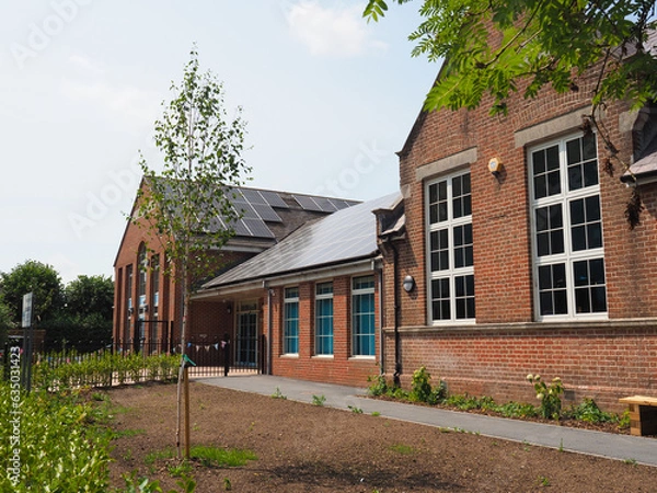 Obraz Newly fitted solar panels on the roof of an old school building