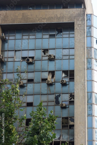 Fototapeta Building almost destroyed by unmanned aerial vehicle. Civil infrastructure damaged by war drone. Terrorism aftermath