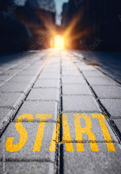 Fototapeta The word start written on the sidewalk leading to the sun's rays 