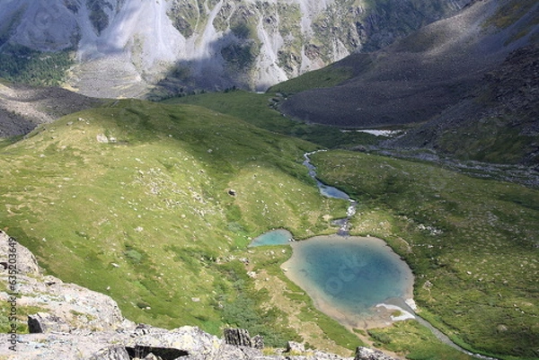 Fototapeta Mountain summer landscape, Altai. Colorful lake in the gorge. Summer hiking in the mountains.