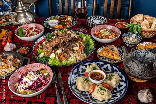Obraz Traditional Uzbek oriental cuisine. Uzbek family table from different dishes for the New Year holiday. The background image is a top view.