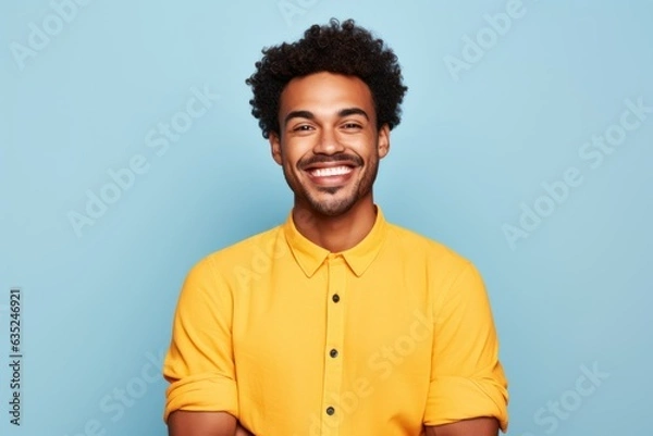 Obraz Portrait of a young fictional man smiling. Isolated on a plain colored background. Generative AI.