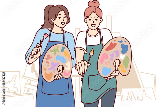 Fototapeta Two women artists hold es and palettes standing in workshop with easels to create artworks