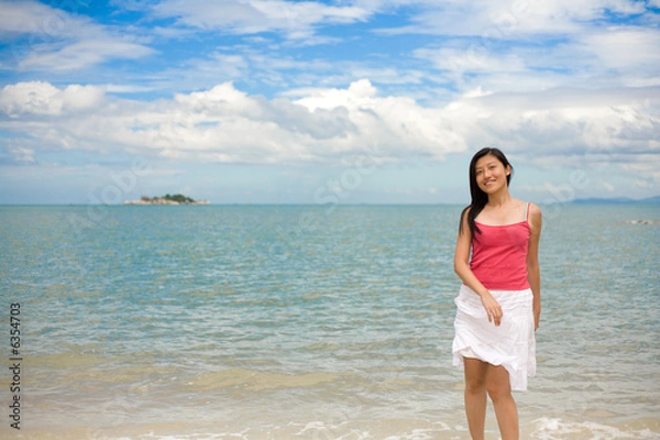 Fototapeta playful woman at the beach on a beautiful day