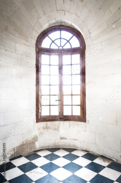 Fototapeta Grungy arched window inside old building.