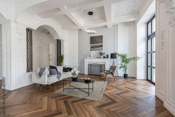 Obraz a chic expensive bright interior of a huge living room in a historic mansion with arched arches, columns and white walls decorated with ornaments and stucco.