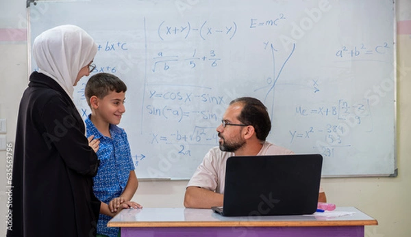 Fototapeta Mother having conversation with the teacher in school about here son academic Progress