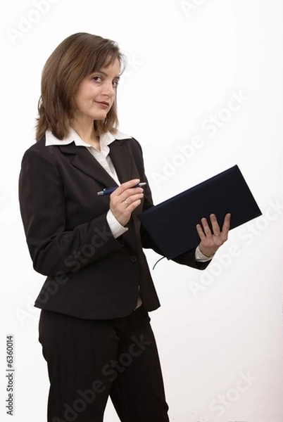 Fototapeta Isolated smiling business woman holding pen and notepad.