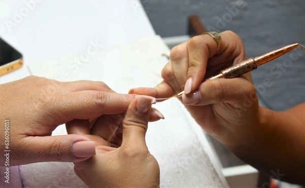 Fototapeta The girl draws with a brush on the niht