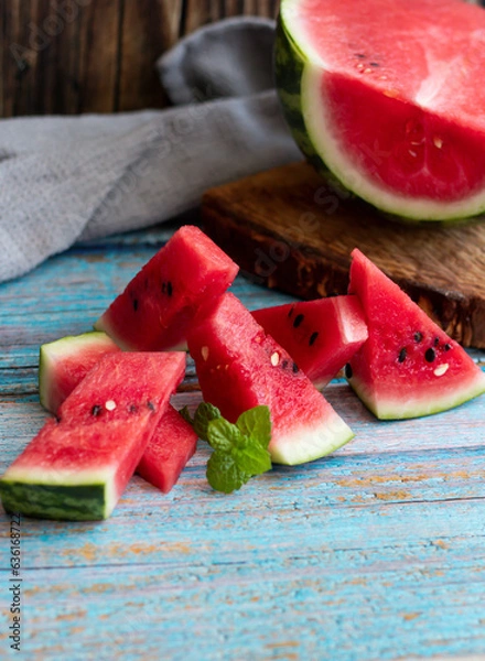 Fototapeta Watermelon slices in a glass on a wooden background. 
Slices of watermelon on a wooden board. 
