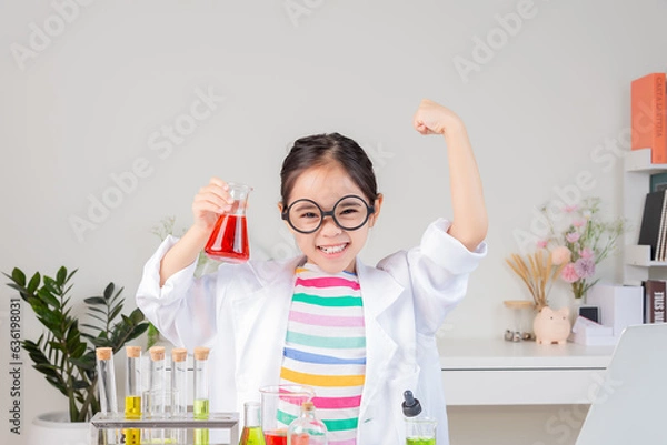 Obraz Asian little girl working with test tube science experiment in white classroom